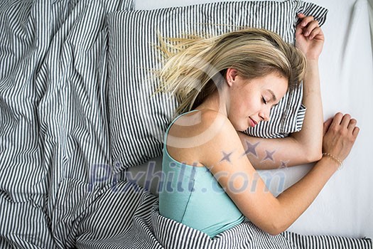 Beautiful young woman sleeping in bed (color toned image; shallow DOF) Beautiful young woman sleeping in bed (color toned image; shallow DOF)
