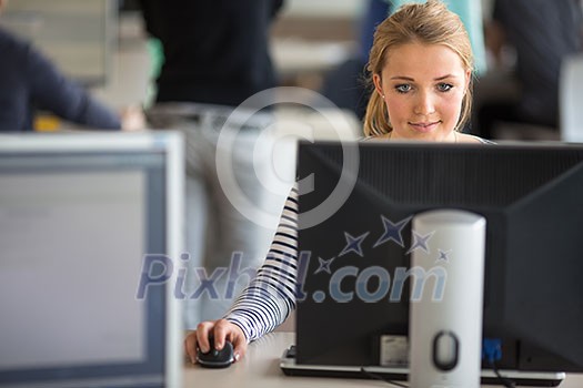 Pretty, female student looking at a desktop computer screen, learning unpleasant news about her exam results. University/office/school concept Pretty, female student looking at a desktop computer screen, learning unpleasant news about her exam results. University/office/school concept