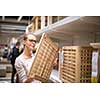Pretty, young woman choosing the right furniture for her apartment in a modern home furnishings store (color toned image; shallow DOF)