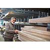 Man choosing and buying construction wood in a DIY store for his DIY home re-modeling project