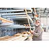Man choosing and buying construction wood in a DIY store for his DIY home re-modeling project