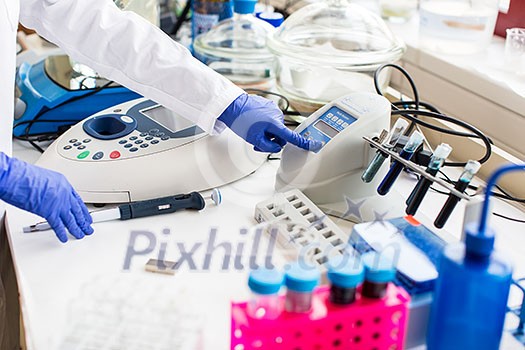 Young female scientist works in modern chemistry/biology lab (shallow DOF; color toned image) Young female scientist works in modern chemistry/biology lab (shallow DOF; color toned image)