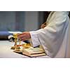 Priest during a wedding ceremony/nuptial mass (shallow DOF; color toned image)