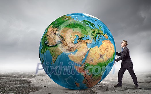 Businessman pushing big Earth planet. Elements of this image are furnished by NASA Businessman pushing big Earth planet. Elements of this image are furnished by NASA