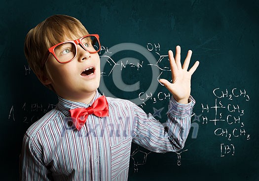 Smart boy in red glasses near blackboard with formulas Smart boy in red glasses near blackboard with formulas