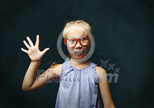 Genius girl in red glasses near blackboard with formulas Genius girl in red glasses near blackboard with formulas