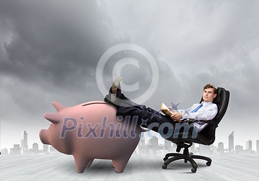 Young handsome businessman sitting in chair. Banking concept Young handsome businessman sitting in chair. Banking concept