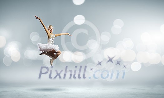 Young pretty ballerina girl making jump in dance Young pretty ballerina girl making jump in dance