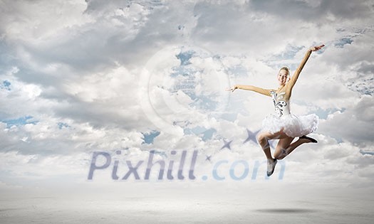 Young pretty ballerina girl making jump in dance Young pretty ballerina girl making jump in dance