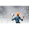 Young woman builder screaming emotionally in megaphone