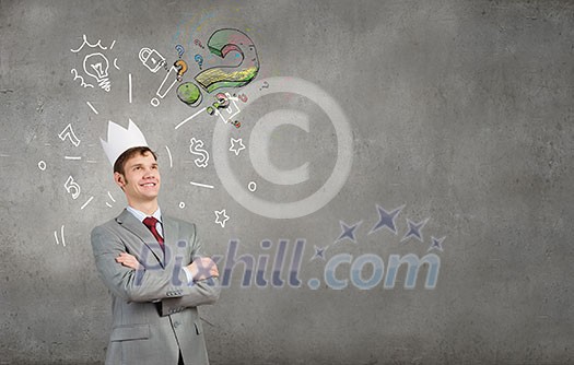 Young handsome businessman wearing white paper crown Young handsome businessman wearing white paper crown