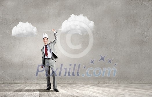 Young businessman in paper crown lifting barbell above head Young businessman in paper crown lifting barbell above head