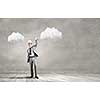 Young businessman in paper crown lifting barbell above head