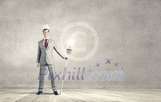 Young handsome businessman wearing white paper crown Young handsome businessman wearing white paper crown
