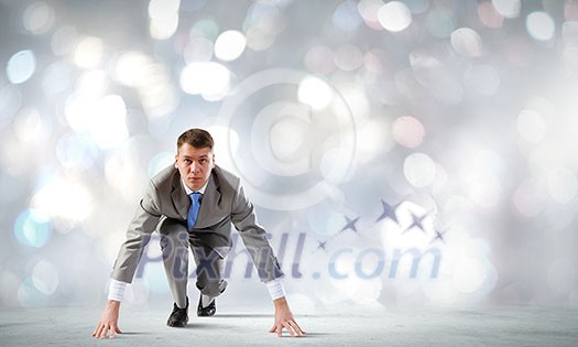 Young determined businessman standing in start position Young determined businessman standing in start position