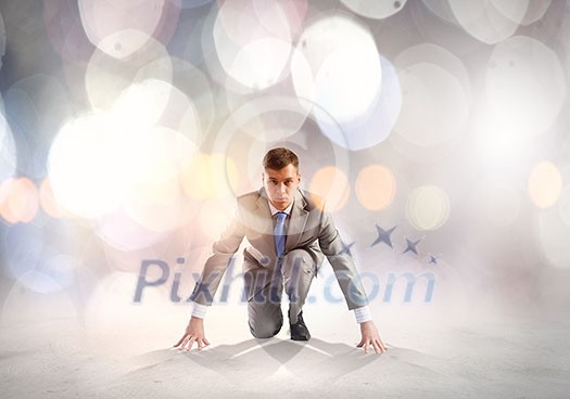 Young determined businessman standing in start position Young determined businessman standing in start position