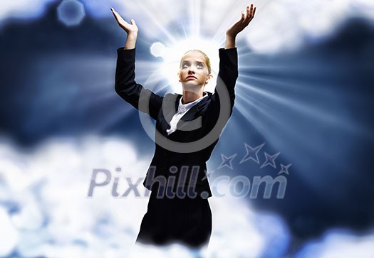 Young praying saint businesswoman with halo above head Young praying saint businesswoman with halo above head