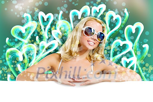 Young attractive blond in bikini holding blank banner Young attractive blond in bikini holding blank banner