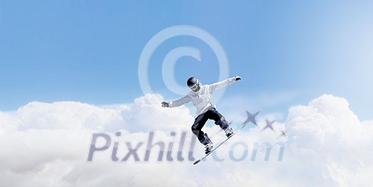 Snowboarder making high jump in clear blue sky Snowboarder making high jump in clear blue sky