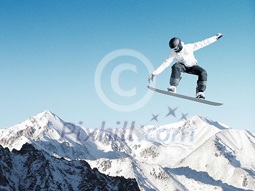Snowboarder making high jump in clear blue sky Snowboarder making high jump in clear blue sky