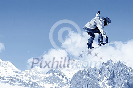 Snowboarder making high jump in clear blue sky Snowboarder making high jump in clear blue sky