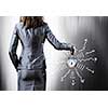 Rear view of businesswoman holding old alarm clock
