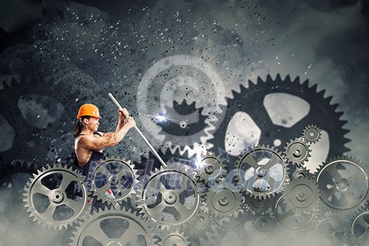 Strong man mechanic in uniform with spanner fixing mechanism Strong man mechanic in uniform with spanner fixing mechanism