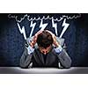 Troubled thoughtful businessman with hands on head