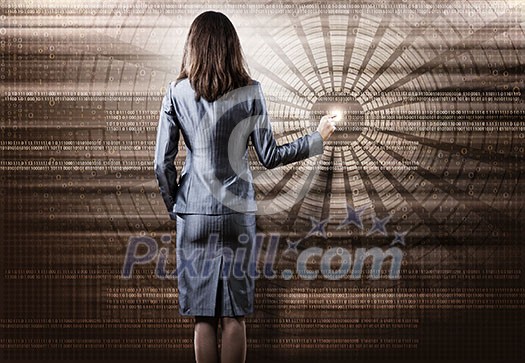 Rear view of busineswoman touching digital screen Rear view of busineswoman touching digital screen