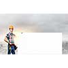 Young repairman holding white blank banner. Place for text