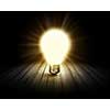 Conceptual image with light bulb and wooden surface