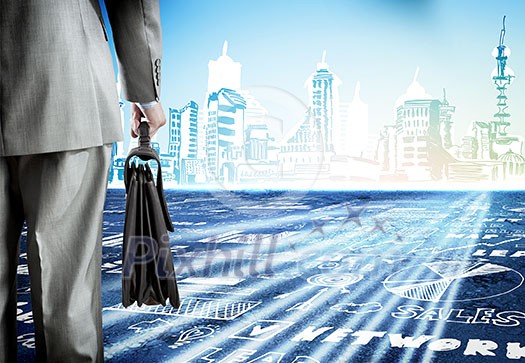 Rear view of businessman with briefcase and sketches at background