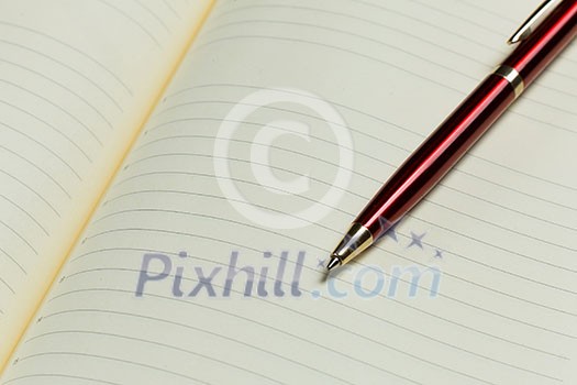Close up of blank opened notepad and pen Close up of blank opened notepad and pen
