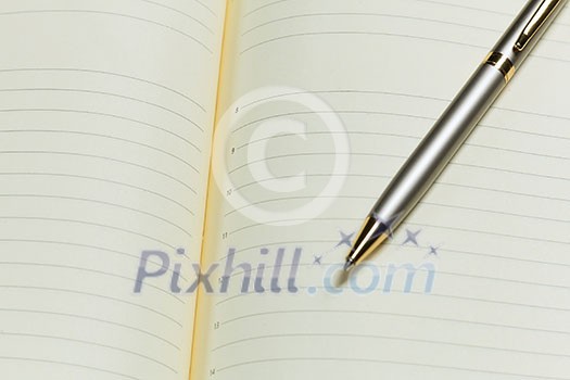 Close up of blank opened notepad and pen Close up of blank opened notepad and pen
