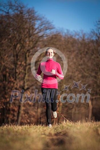 Young woman running outdoors on a lovely sunny winter/fall day Young woman running outdoors on a lovely sunny winter/fall day