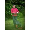 Senior man mowing the lawn in his garden