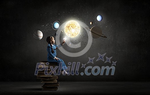 Little girl sitting on stack of books and touching planet Little girl sitting on stack of books and touching planet