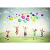 Group of happy children playing with colorful balloons