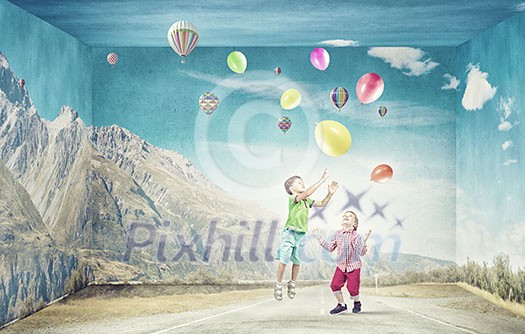 Little cute boys playing joyfully with colorful balloon Little cute boys playing joyfully with colorful balloon