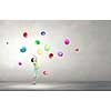 Little cute boy playing joyfully with colorful balloon