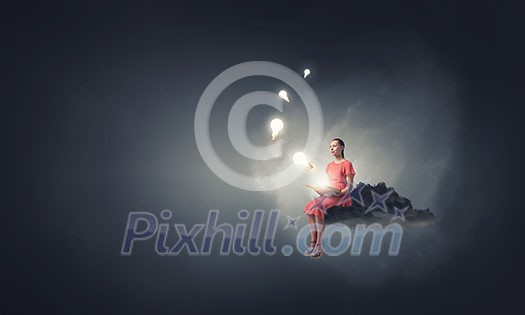 Young woman in dress with old book in hand sitting on cloud Young woman in dress with old book in hand sitting on cloud