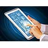 Close up of finger touching blue toned screen on tablet pc