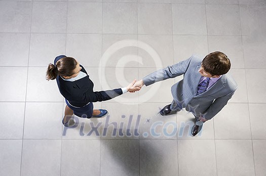 Top view of business partners shaking hands as a symbol of unity Top view of business partners shaking hands as a symbol of unity