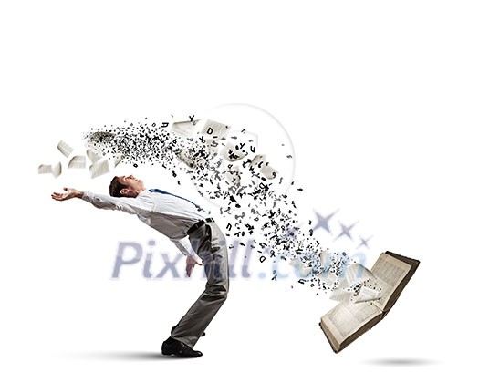 Young man benting to evade characters flying from book Young man benting to evade characters flying from book