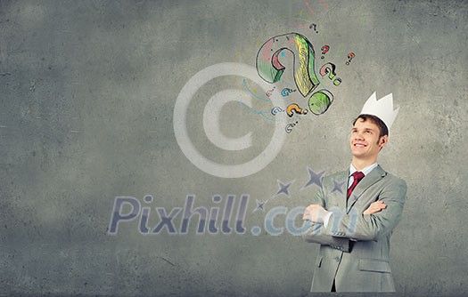 Young handsome businessman wearing white paper crown Young handsome businessman wearing white paper crown