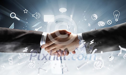 Close up of business handshake on digital background Close up of business handshake on digital background