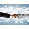 Close up of business handshake on digital background