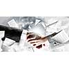 Close up of business handshake with papers at background