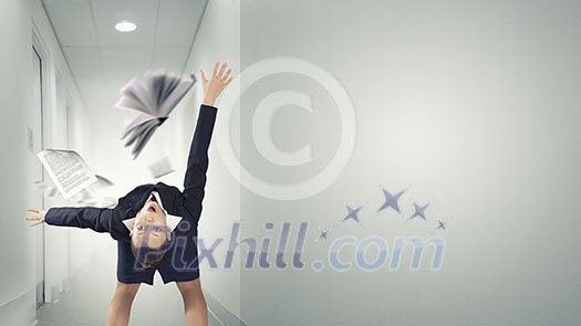 Businesswoman bent over and evading from book Businesswoman bent over and evading from book