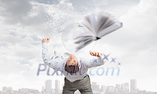 Businessman bent over and evading from book Businessman bent over and evading from book